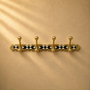 Handcrafted Moroccan brass coat rack with black-and-white resin diamond inlay and 4 hooks. Bold wall hooks for any room.