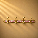 Handcrafted Moroccan brass coat rack with soft pink resin diamond inlay and 4 hooks. Pretty wall hooks for bedroom, bath, or entry.