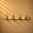 Moroccan brass rack with warm yellow resin inlay and 4 hooks. Handmade wall-mounted hooks for coats, towels, and bags.