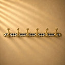  Handcrafted Moroccan brass coat rack with black-and-white resin diamond inlay and 6 hooks. Bold wall hooks for any room.