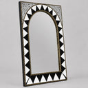 Decorative mirror with black and white geometric pattern on a gray background