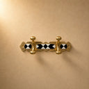 Handcrafted Moroccan brass coat rack with black-and-white resin diamond inlay and 2 hooks. Bold wall hooks for any room.