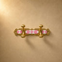 Handcrafted Moroccan brass coat rack with soft pink resin diamond inlay and 2 hooks. Pretty wall hooks for bedroom, bath, or entry.