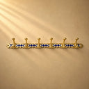 Handcrafted Moroccan brass coat rack with black-and-white resin diamond inlay and 6 hooks. Bold wall hooks for any room.