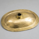 Gold-colored metal lid on a gray background