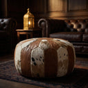 Patchwork ottoman in a dimly lit room with leather furniture