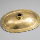 Gold-colored metal lid on a gray background