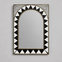 Decorative mirror with black and white geometric pattern on a gray background