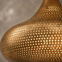 Moroccan brass chandelier-style pendant light suspended from the ceiling with intricate artisan metalwork.