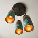 Artisan oxidized copper pendant light with green patina finish hanging in a contemporary luxury interior.