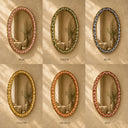 Set of five oval mirrors with decorative frames in different colors on a beige background.